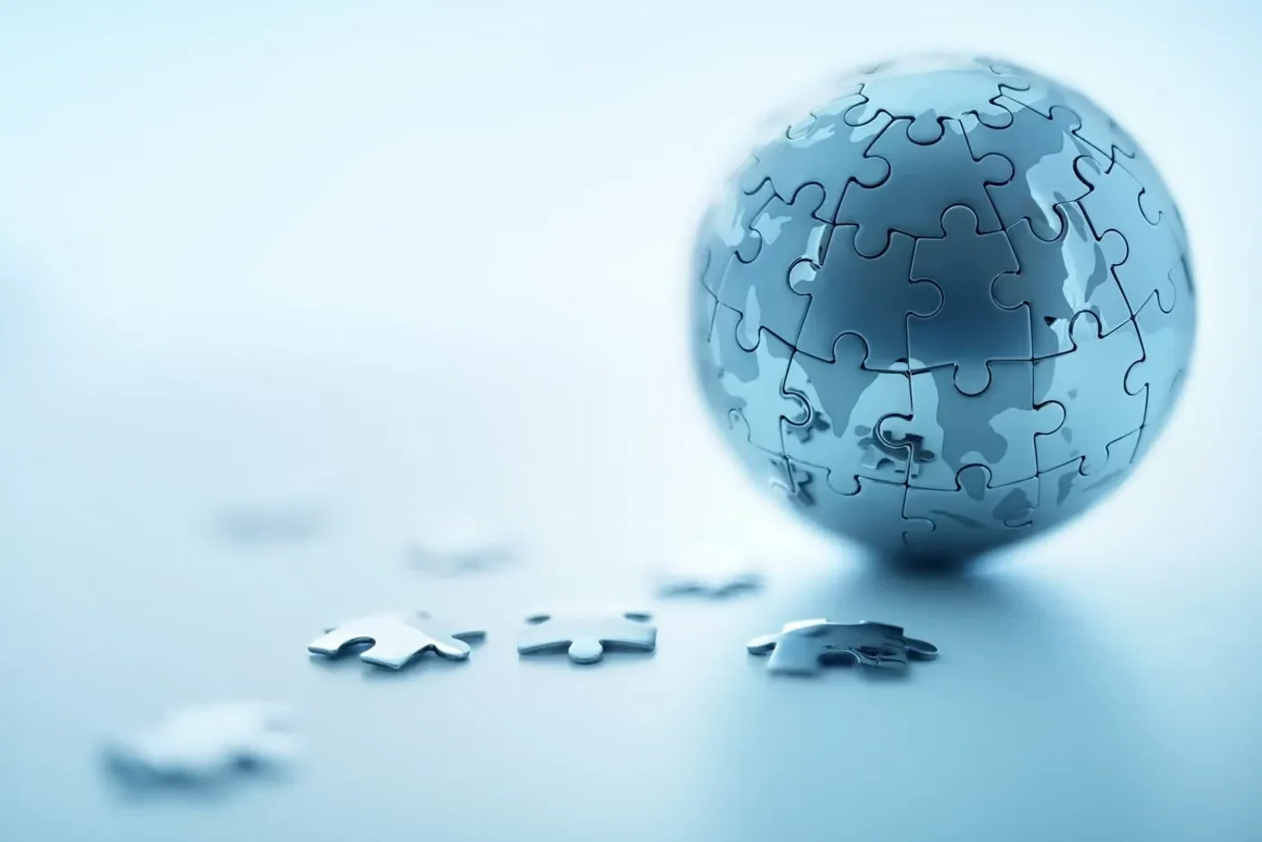 A jigsaw-puzzle globe with a few pieces set beside it