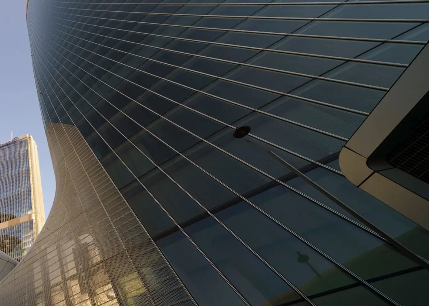 The curved glass facade of an office building